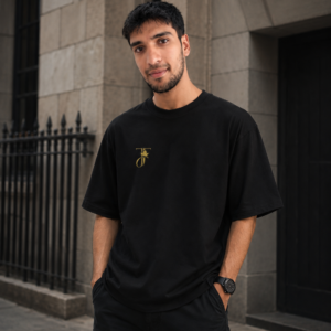 Black JFS Embroidered Oversized T-Shirt featuring a minimalist gold embroidered chest logo on heavyweight cotton fabric